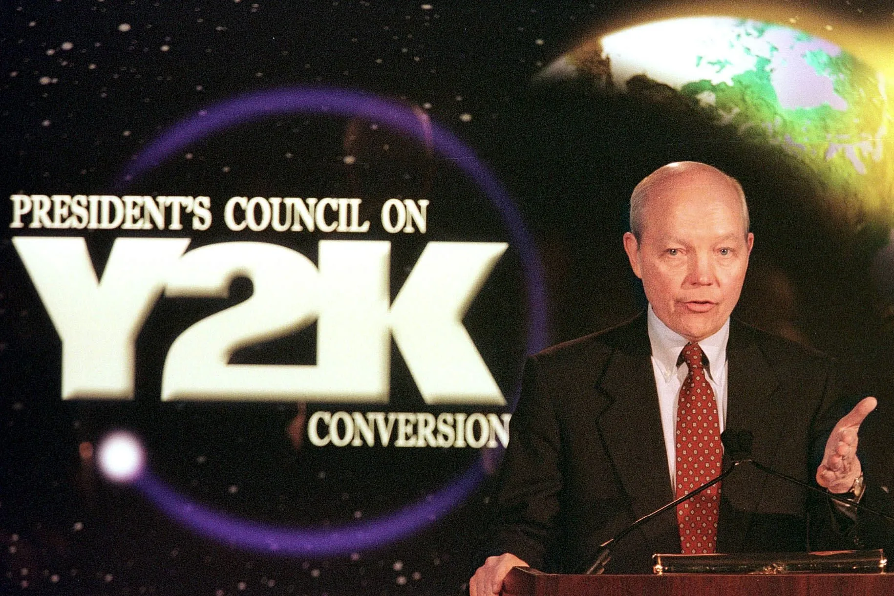 John Koskinen speaks with members of the media